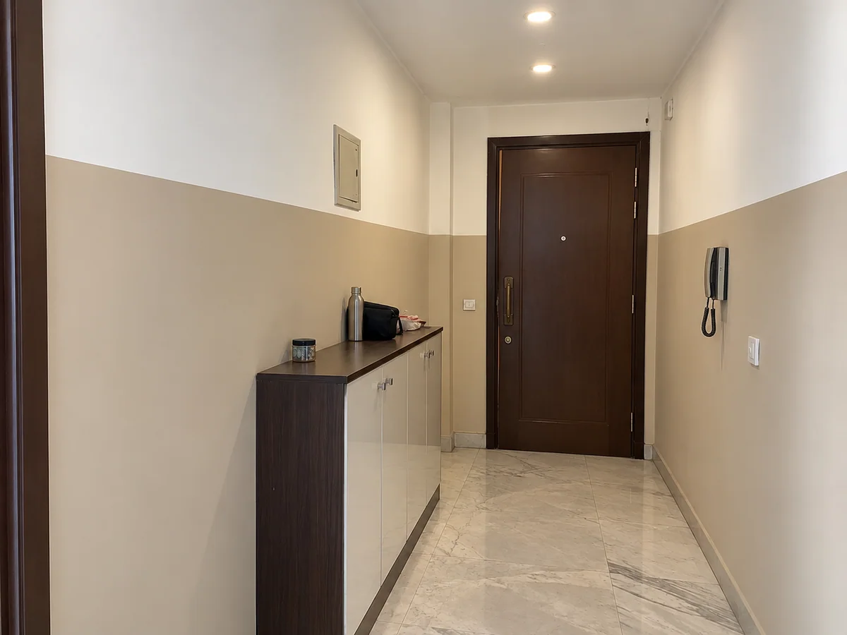 Entrance corridor — scuffed walls repainted two-tone — after