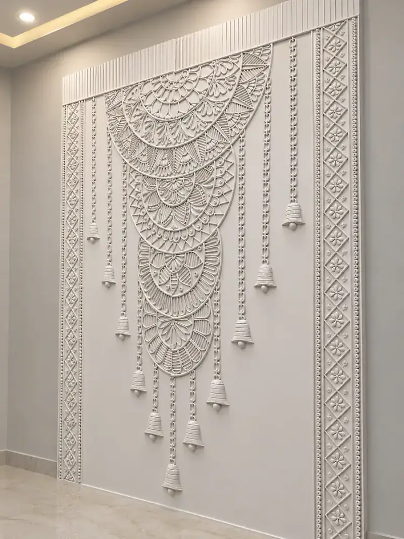 White carved relief feature panel with a mandala arch and hanging bell motifs