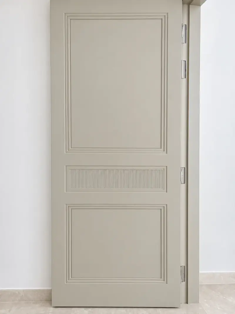 Interior door with raised panels and a fluted centre band in a sprayed finish